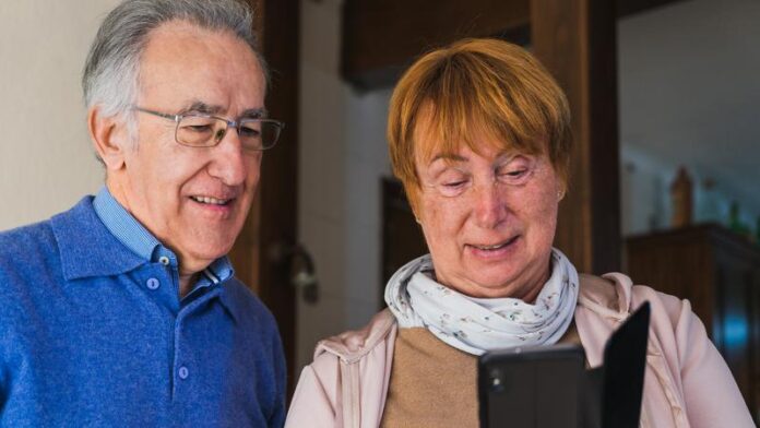 mp54642929-old-couple-looking-at-mobile-in-house.jpg