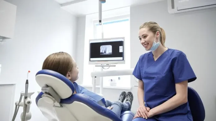 mp16531019-happy-female-dentist-with-patient-girl-at-clinic.webp.webp