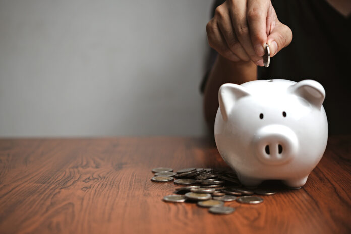 Banking savings money investing insurance planning real real estate support relationship parent economic income budget.hand putting money coin into piggy.