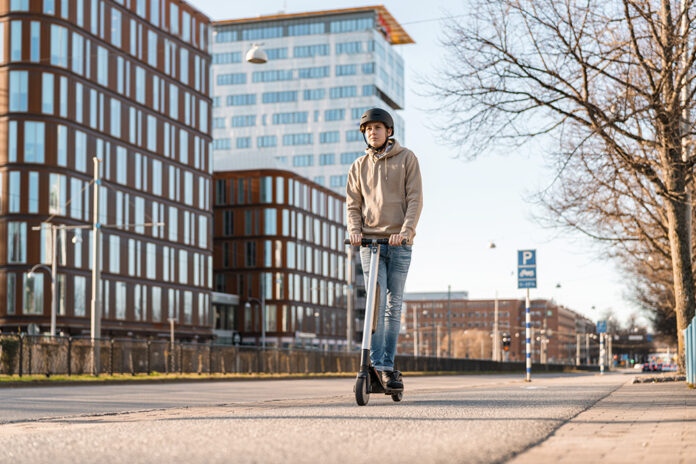 Teenager riding an Electric Scooter in the City